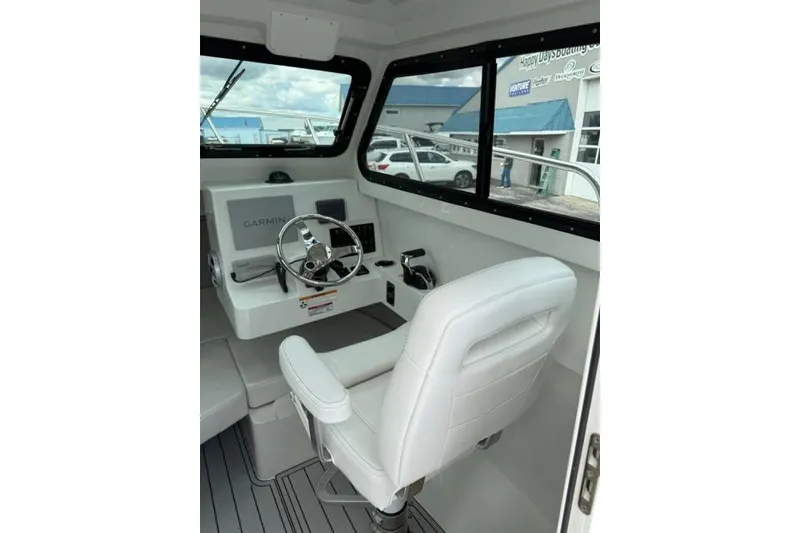 Slide: The Image of Interior of 2026 Parker 227 Explorer boat with steering wheel and Garmin display. - 7