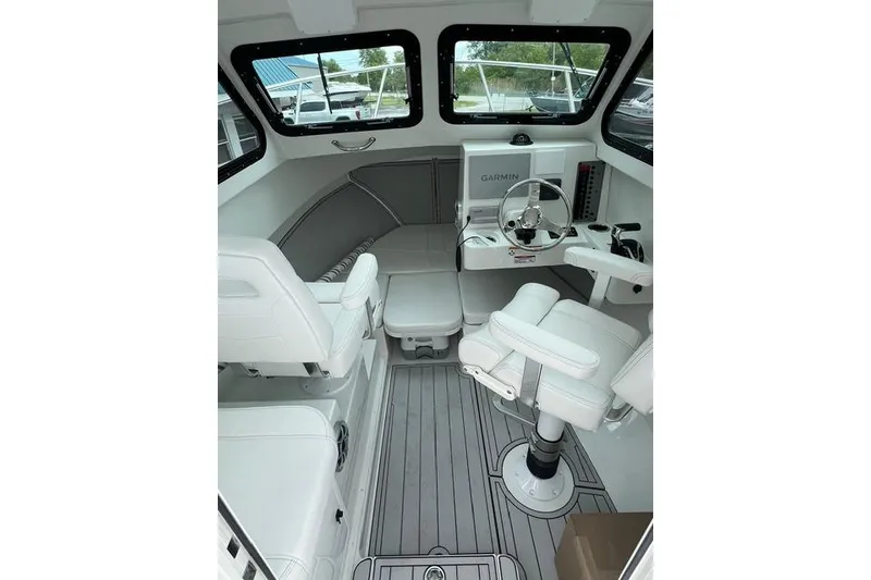 Slide: The Image of Interior of 2026 Parker 247 Explorer boat with modern helm and seating. - 10