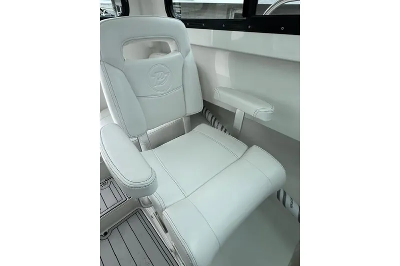 Slide: The Image of White leather seat in 2026 Parker 247 Explorer boat interior. - 12