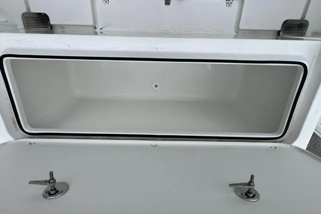 Slide: The Image of Storage compartment of 2026 Parker 247 Explorer boat, featuring secure latches and spacious interior. - 15