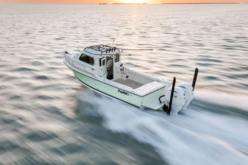 Slide: The Image of Manufacturer Provided Image: 2026 Parker 247 Explorer boat cruising at sunset on open water. - 2