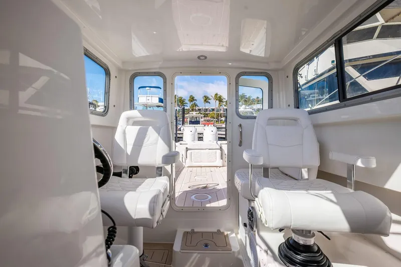 Slide: The Image of Manufacturer Provided Image: Interior of 2026 Parker 247 Explorer boat with white seating and modern design. - 4