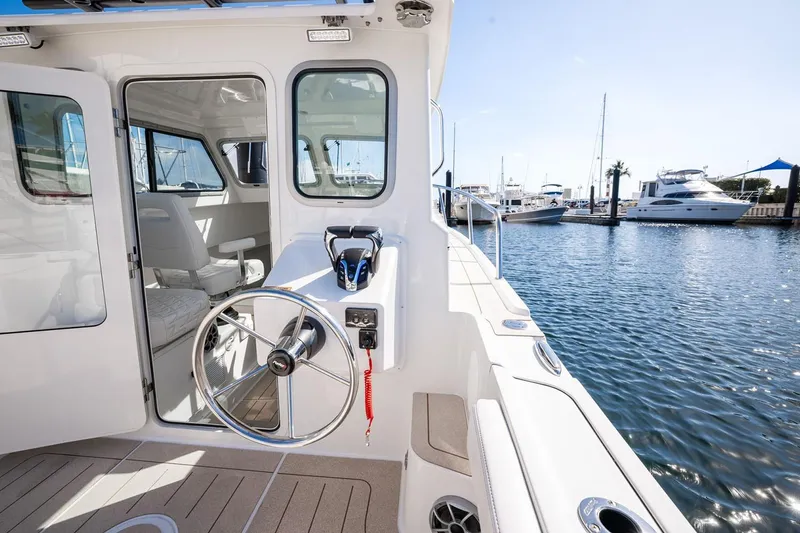 Slide: The Image of Manufacturer Provided Image: 2026 Parker 247 Explorer boat docked, featuring helm and marina view. - 6