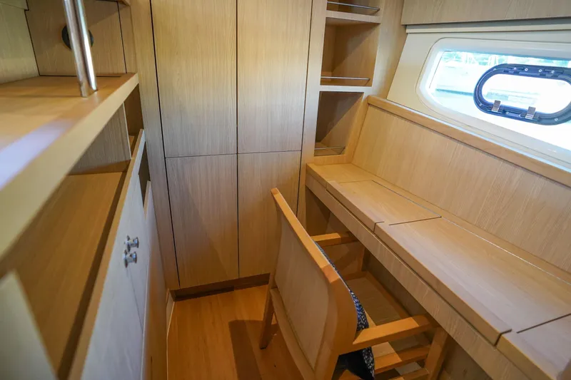Slide: The Image of Interior of 2021 Aquila 44 Yacht with wooden desk and shelving. - 16