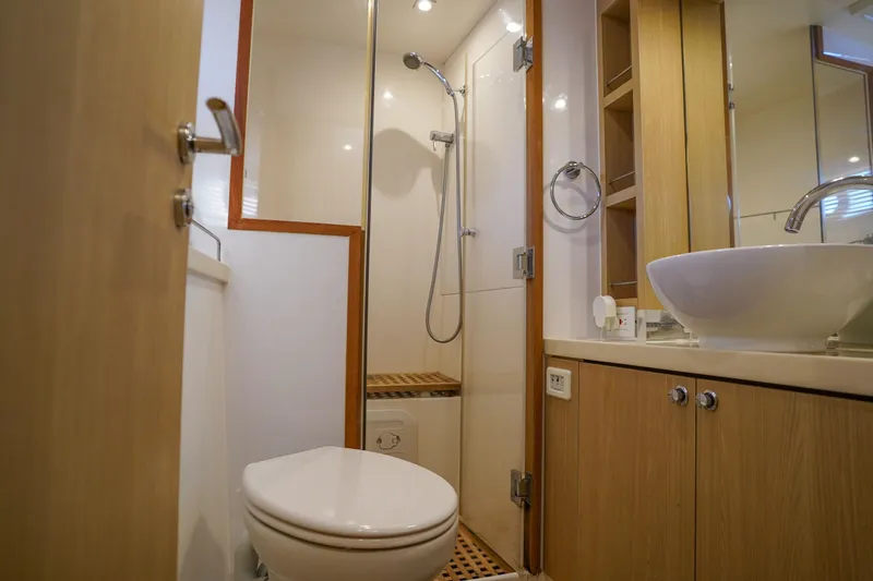 Slide: The Image of Modern bathroom interior on 2021 Aquila 44 Yacht, featuring shower, sink, and toilet. - 19