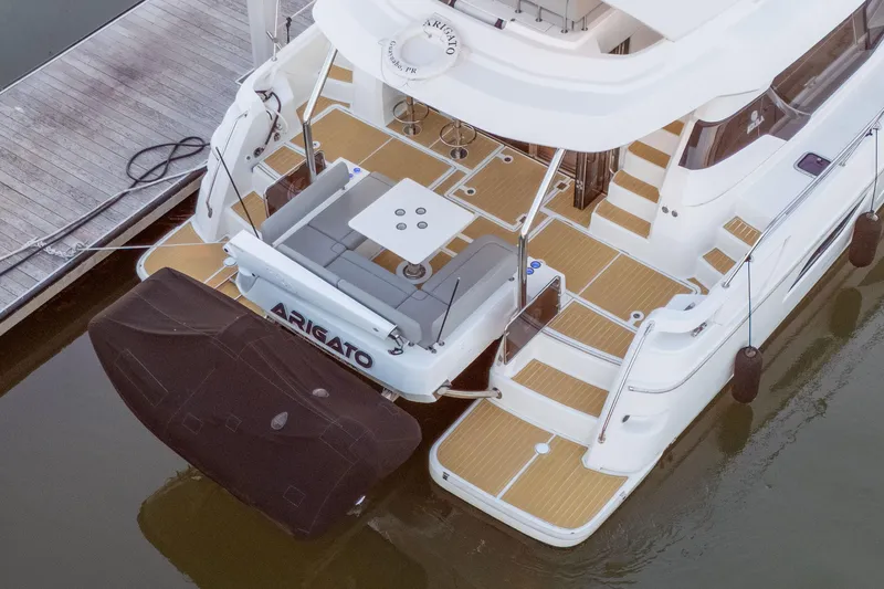 Slide: The Image of Aquila 44 Yacht 2021 docked, featuring spacious deck and seating area. - 2