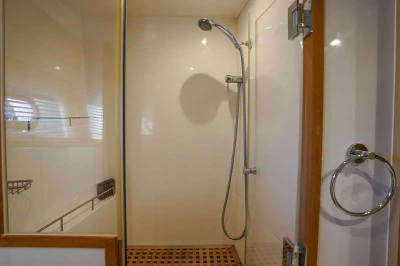 Slide: The Image of Shower area in 2021 Aquila 44 Yacht with modern fixtures and wooden accents. - 21