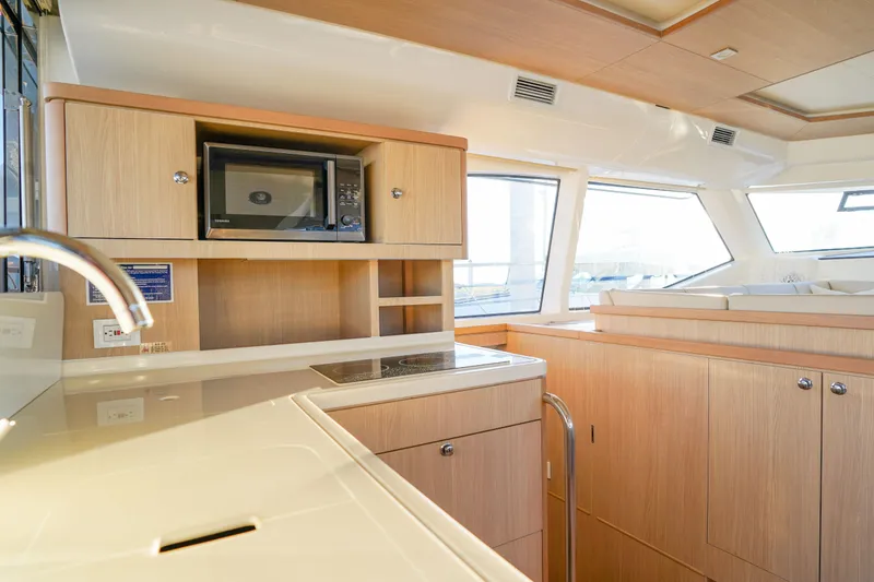 Slide: The Image of Modern kitchen interior of 2021 Aquila 44 Yacht with wooden cabinetry and appliances. - 27
