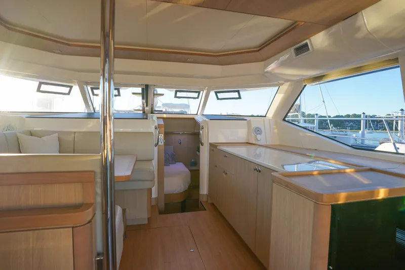 Slide: The Image of Interior of 2021 Aquila 44 Yacht with modern wood finishes and ample natural light. - 28