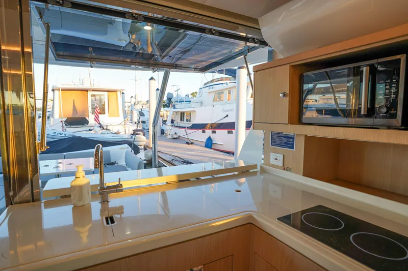 Slide: The Image of Interior view of 2021 Aquila 44 Yacht kitchen with dockside marina view. - 29