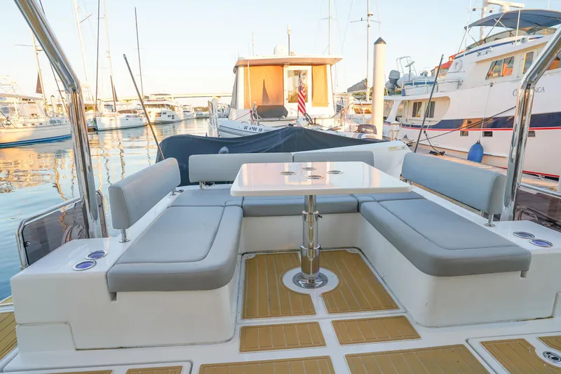 Slide: The Image of Aquila 44 Yacht 2021 with elegant seating area in marina setting. - 30