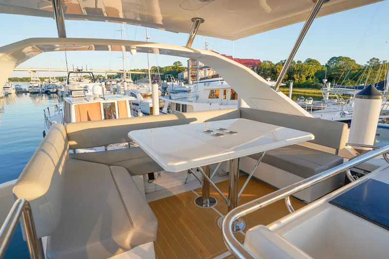 Slide: The Image of Luxurious 2021 Aquila 44 Yacht with elegant seating area in a marina setting. - 36