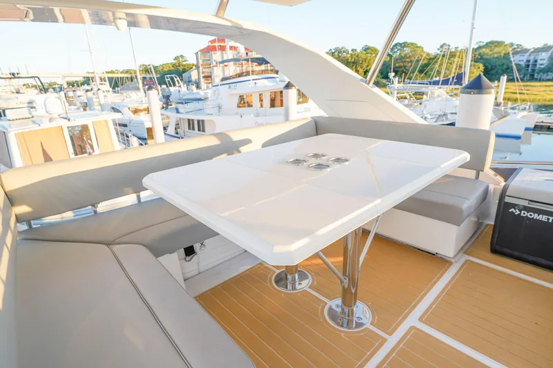 Slide: The Image of Luxurious seating area on 2021 Aquila 44 Yacht, featuring a sleek white table and comfortable cushions. - 38