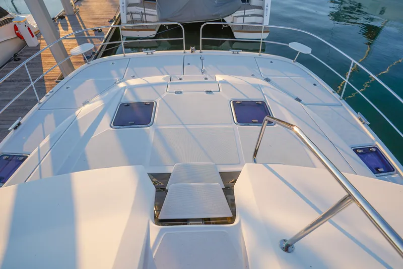 Slide: The Image of Aquila 44 Yacht 2021 deck with hatches and railing in marina setting. - 49