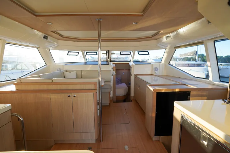 Slide: The Image of Luxurious interior of 2021 Aquila 44 Yacht with modern wood finishes and ample seating. - 7