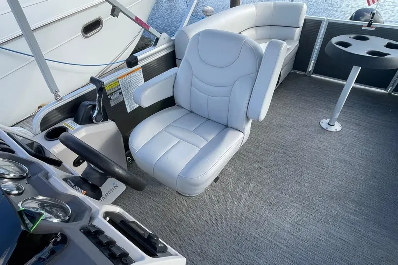 Slide: The Image of Captain's seat on 2023 Godfrey Sweetwater 2086 SB pontoon boat, featuring modern controls. - 20