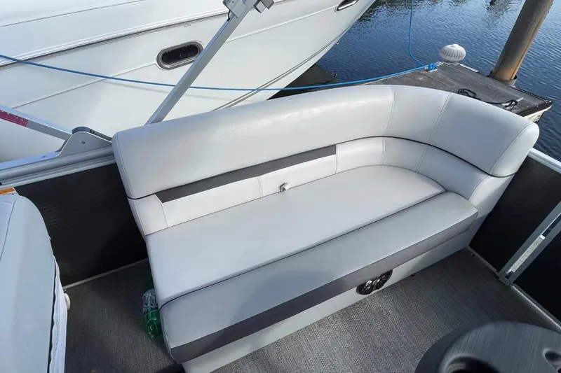 Slide: The Image of 2023 Godfrey Sweetwater 2086 SB boat with sleek white seating and modern design. - 23