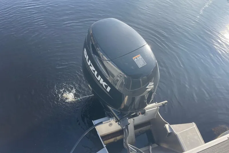 Slide: The Image of 2023 Godfrey Sweetwater 2086 SB with Suzuki outboard motor on water. - 28