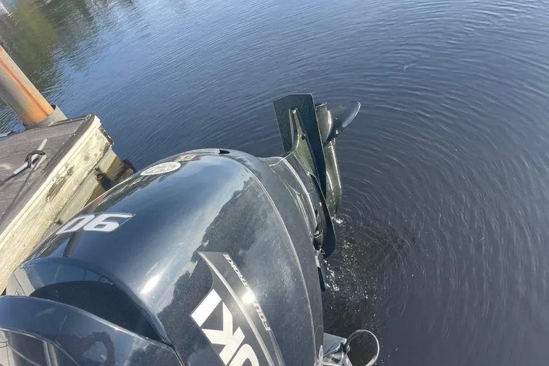Slide: The Image of Outboard motor on a 2023 Godfrey Sweetwater 2086 SB pontoon boat by a dock. - 30
