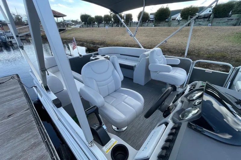 Slide: The Image of 2023 Godfrey Sweetwater 2086 SB pontoon boat interior with plush seating and steering console. - 4