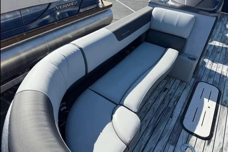 Slide: The Image of 2025 Veranda Relax VR25RC pontoon boat with luxurious seating on wooden deck. - 10