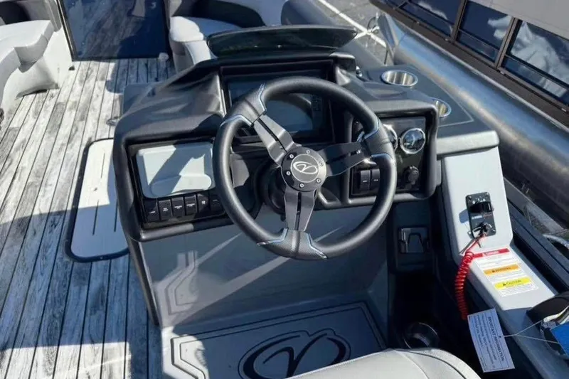 Slide: The Image of 2025 Veranda Relax VR25RC boat steering console with modern controls and wood-style flooring. - 7