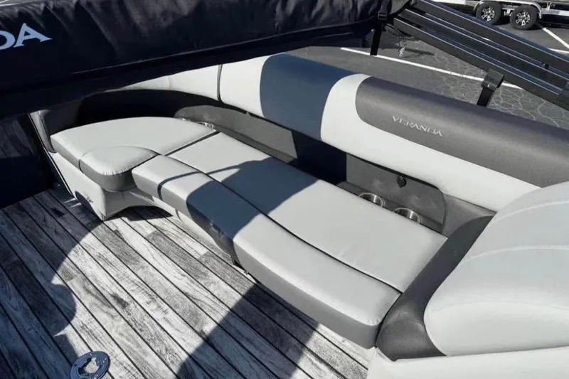 Slide: The Image of 2025 Veranda Relax VR25RC boat interior with sleek, comfortable seating on wooden deck. - 9