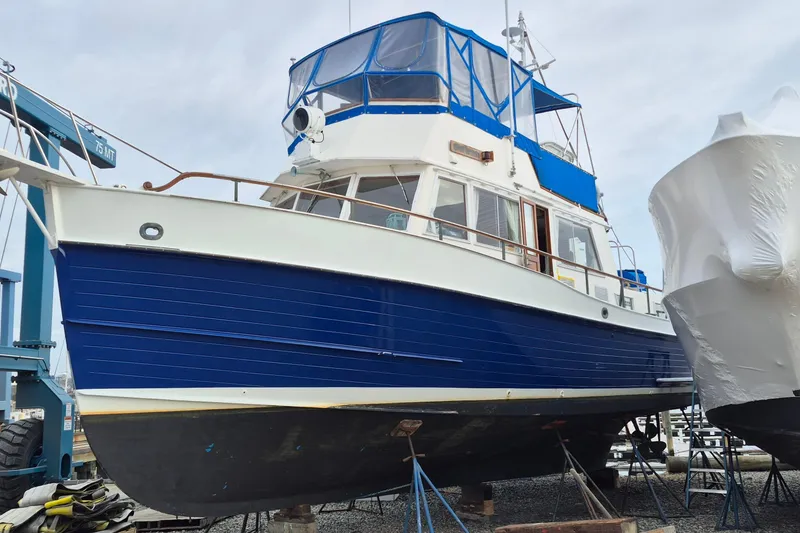 The Image of 1983 Grand Banks 42 Classic yacht with blue hull on dry dock. - 0