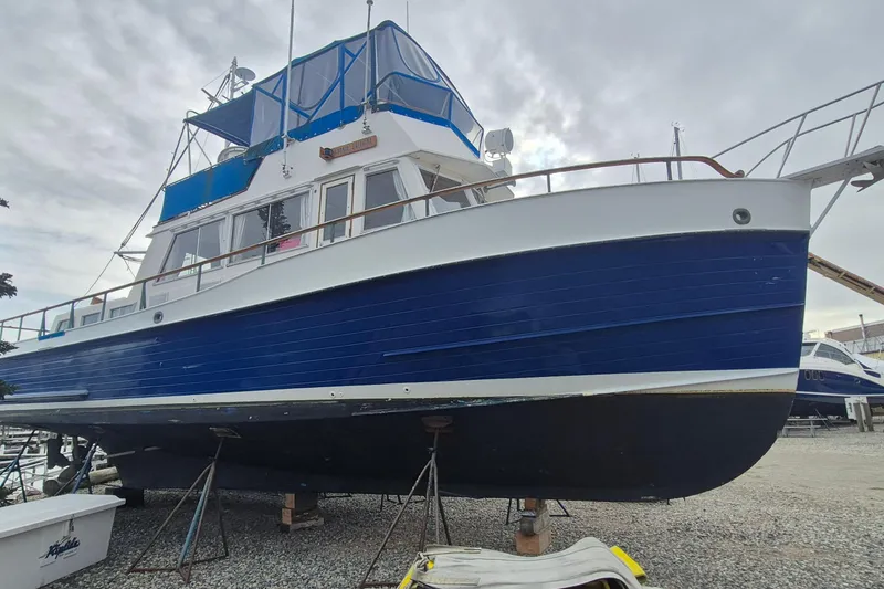 Slide: The Image of 1983 Grand Banks 42 Classic yacht on dry dock, blue and white exterior. - 1