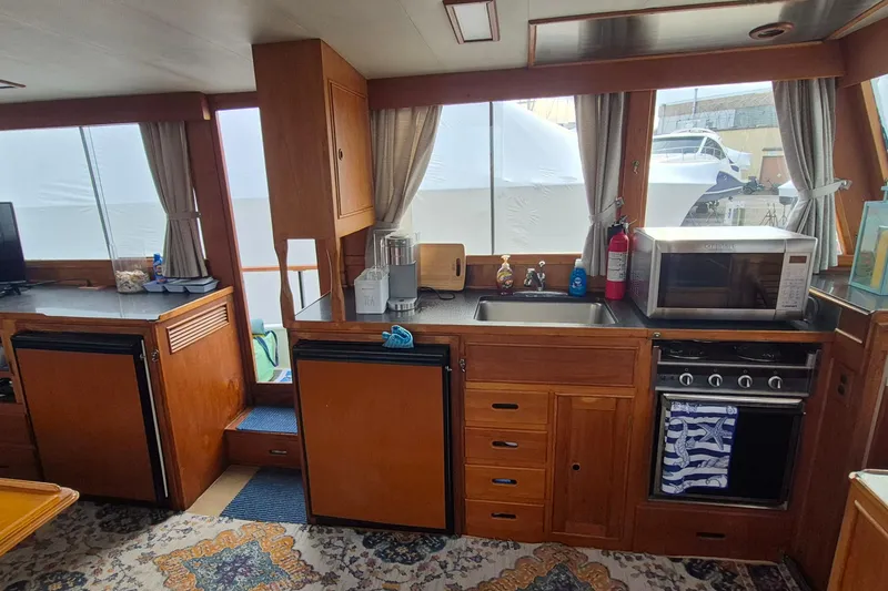 Slide: The Image of Interior of 1983 Grand Banks 42 Classic yacht with blue seating and patterned rugs. - 10