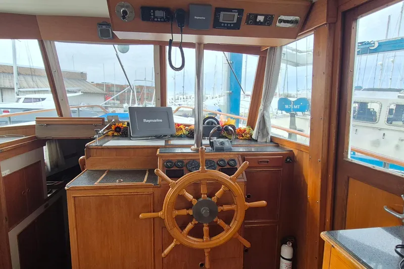 Slide: The Image of Electric stove with four coil burners and control knobs on a 1983 Grand Banks 42 Classic. - 12