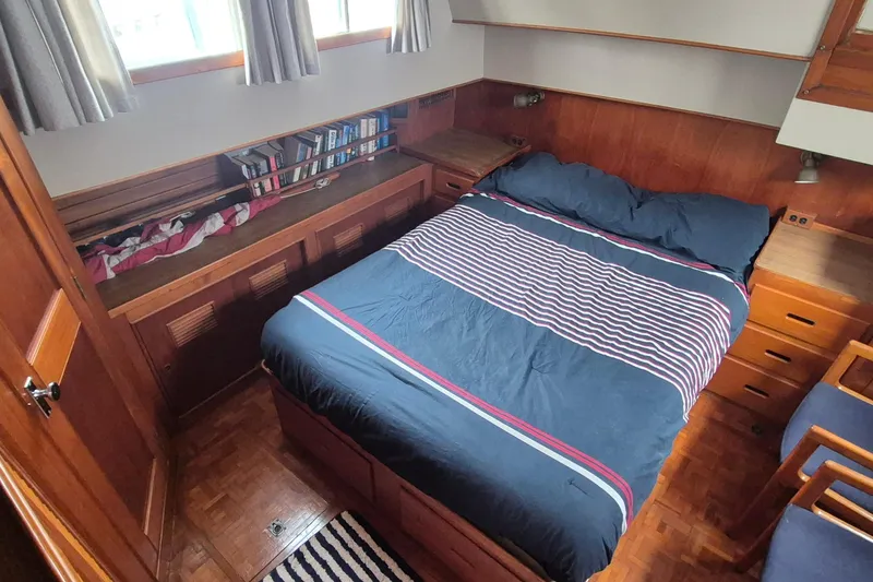 Slide: The Image of Interior helm of 1983 Grand Banks 42 Classic yacht with wooden wheel and navigation equipment. - 13