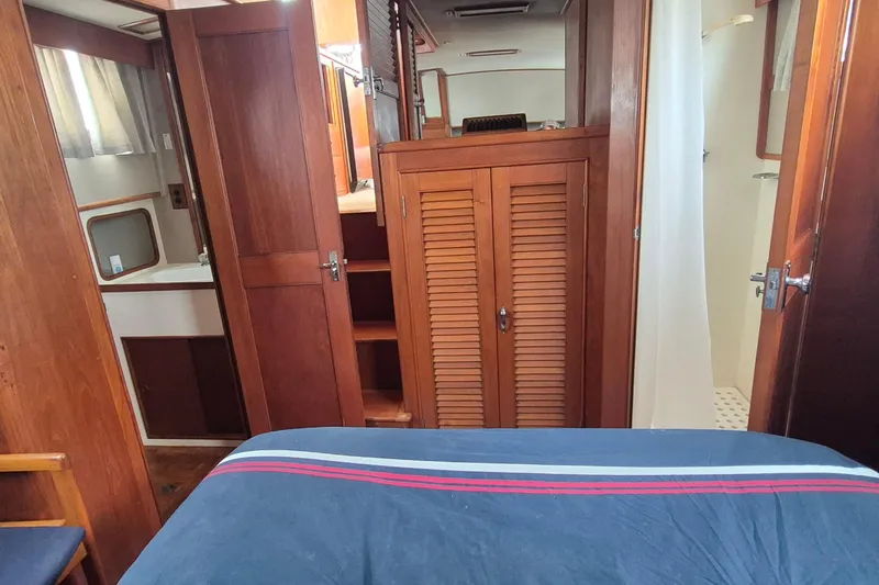 Slide: The Image of 1983 Grand Banks 42 Classic cabin interior with wooden furnishings and nautical decor. - 16