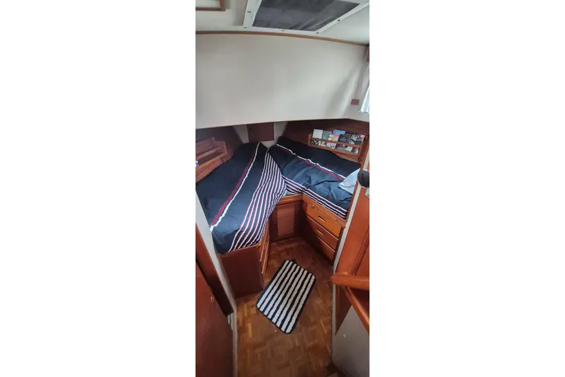 Slide: The Image of Cozy cabin interior of 1983 Grand Banks 42 Classic with twin beds and bookshelves. - 19