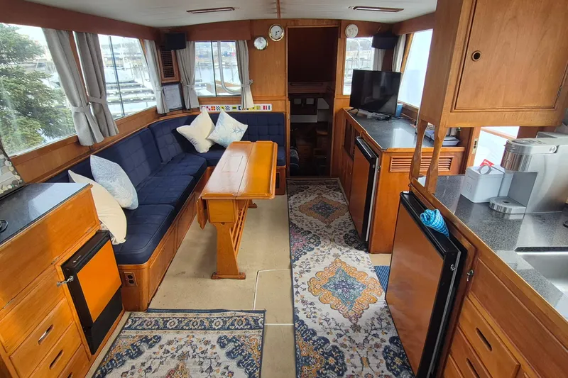 Slide: The Image of Interior of 1983 Grand Banks 42 Classic yacht with cozy seating and wooden cabinetry. - 2