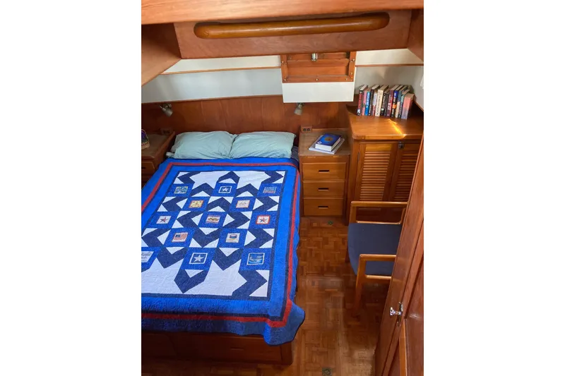Slide: The Image of Cozy cabin interior of 1983 Grand Banks 42 Classic yacht with striped bedding. - 20