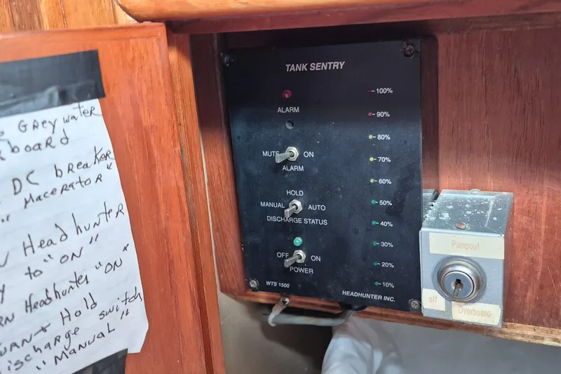 Slide: The Image of Hand holding a smartswitch control panel on a 1983 Grand Banks 42 Classic boat. - 24