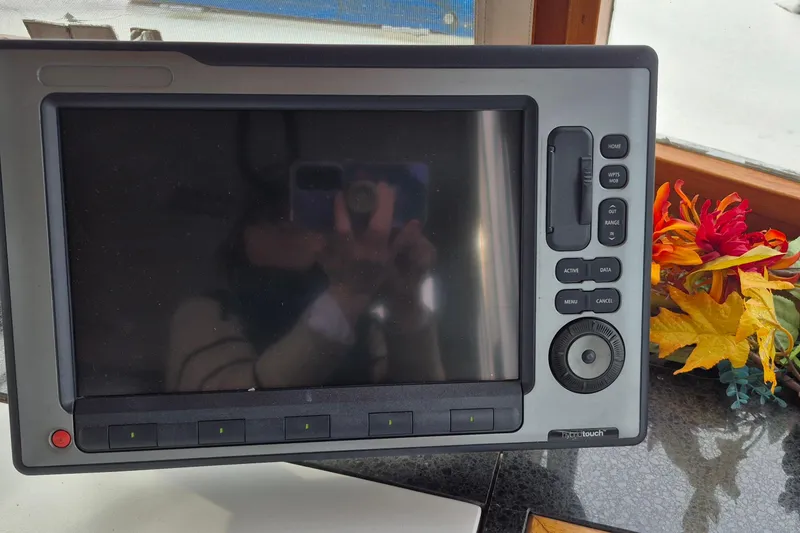 Slide: The Image of Control panel of a 1983 Grand Banks 42 Classic yacht with various switches and dials. - 27