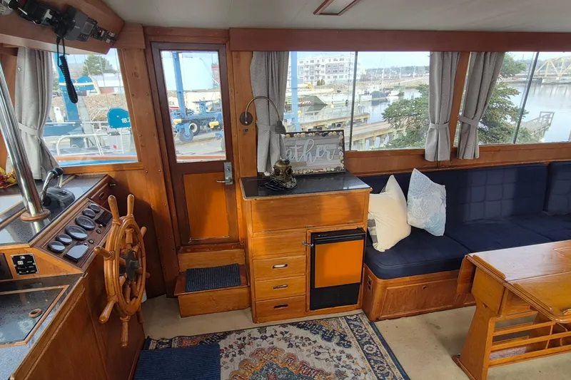 Slide: The Image of Interior of 1983 Grand Banks 42 Classic yacht with wooden helm and cozy seating area. - 3