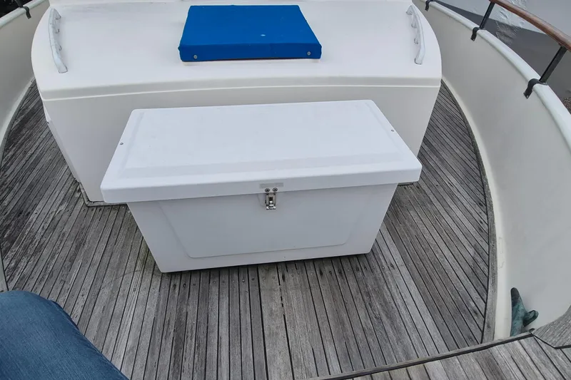 Slide: The Image of 1983 Grand Banks 42 Classic yacht with blue accents docked at marina. - 38