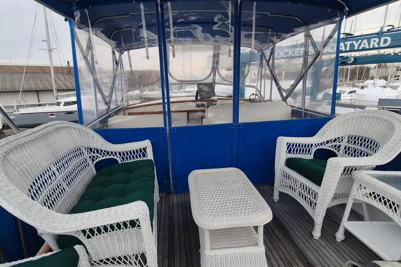 Slide: The Image of 1983 Grand Banks 42 Classic boat deck with storage box and blue cushion. - 39