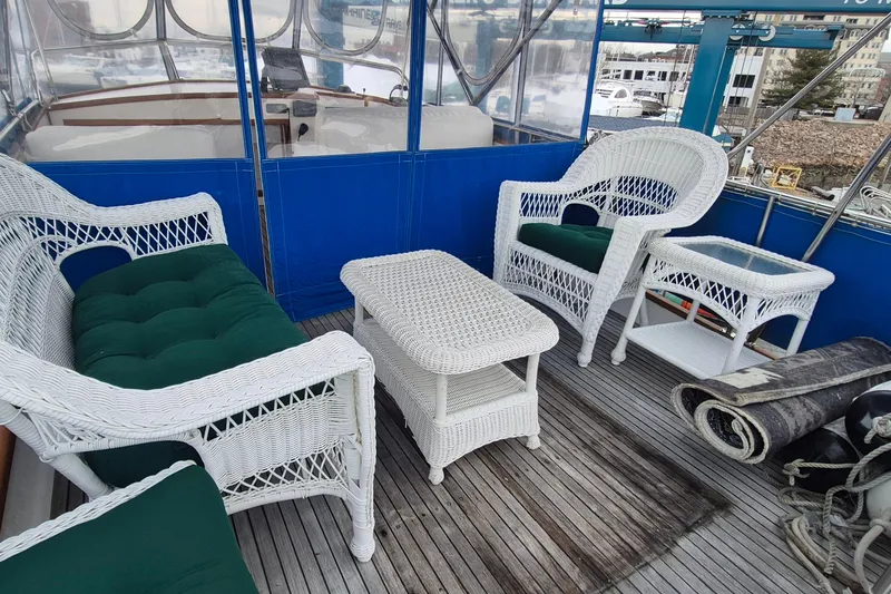 Slide: The Image of Interior of 1983 Grand Banks 42 Classic yacht with wicker furniture and blue accents. - 41