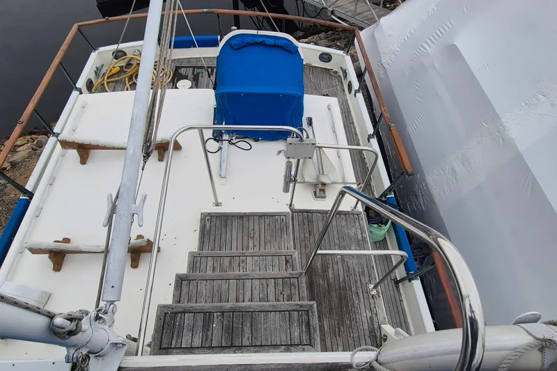 Slide: The Image of Helm of 1983 Grand Banks 42 Classic yacht with wooden wheel and navigation equipment. - 45