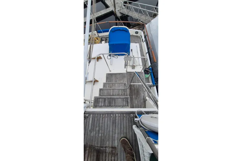 Slide: The Image of 1983 Grand Banks 42 Classic yacht deck with blue cover, docked at marina. - 47