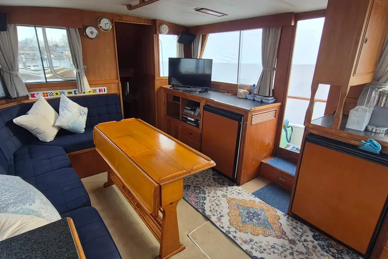 Slide: The Image of Interior of 1983 Grand Banks 42 Classic yacht with cozy seating and wooden furnishings. - 5