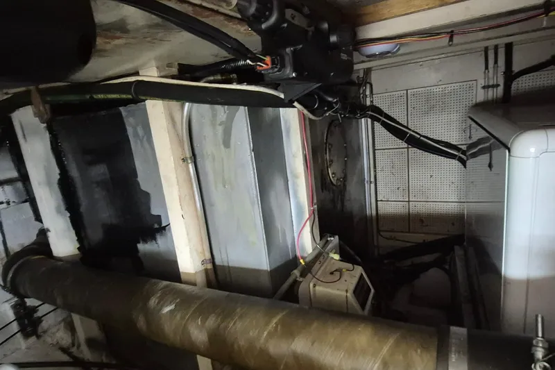 Slide: The Image of Engine room of 1983 Grand Banks 42 Classic with electrical components and wiring. - 62