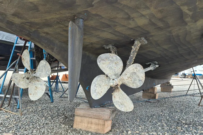Slide: The Image of 1983 Grand Banks 42 Classic yacht on dry dock, showing propellers and hull details. - 76