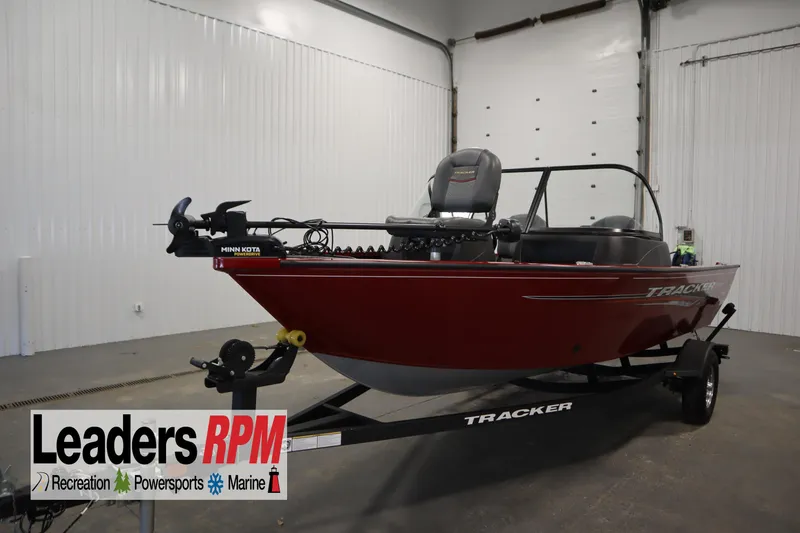 The Image of 2024 Tracker Pro Guide V-16 WT boat in showroom, featuring Minn Kota trolling motor. - 1