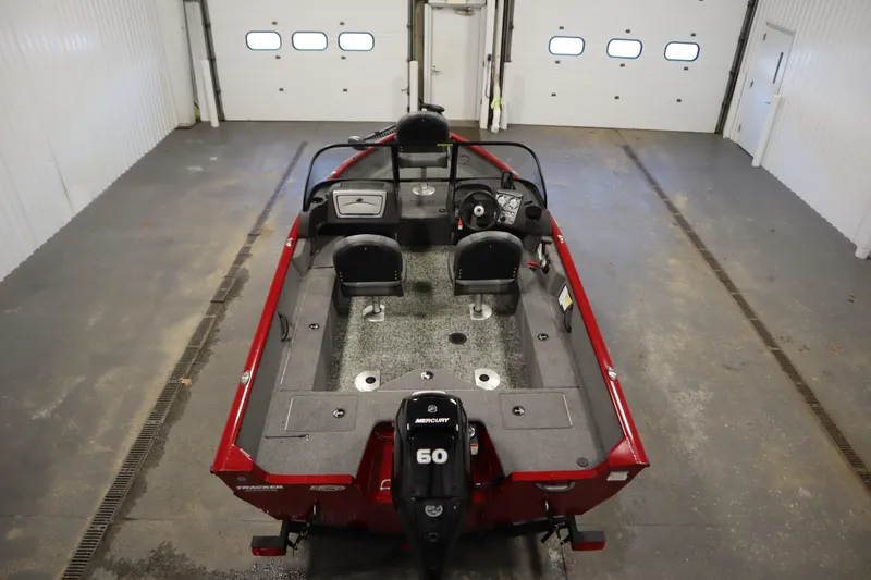 Slide: The Image of 2024 Tracker Pro Guide V-16 WT boat in a garage, featuring a Mercury 60 engine. - 10
