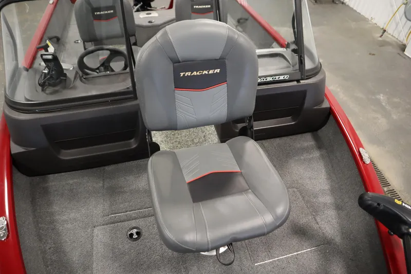 Slide: The Image of 2024 Tracker Pro Guide V-16 WT boat interior with gray seating and steering console. - 15